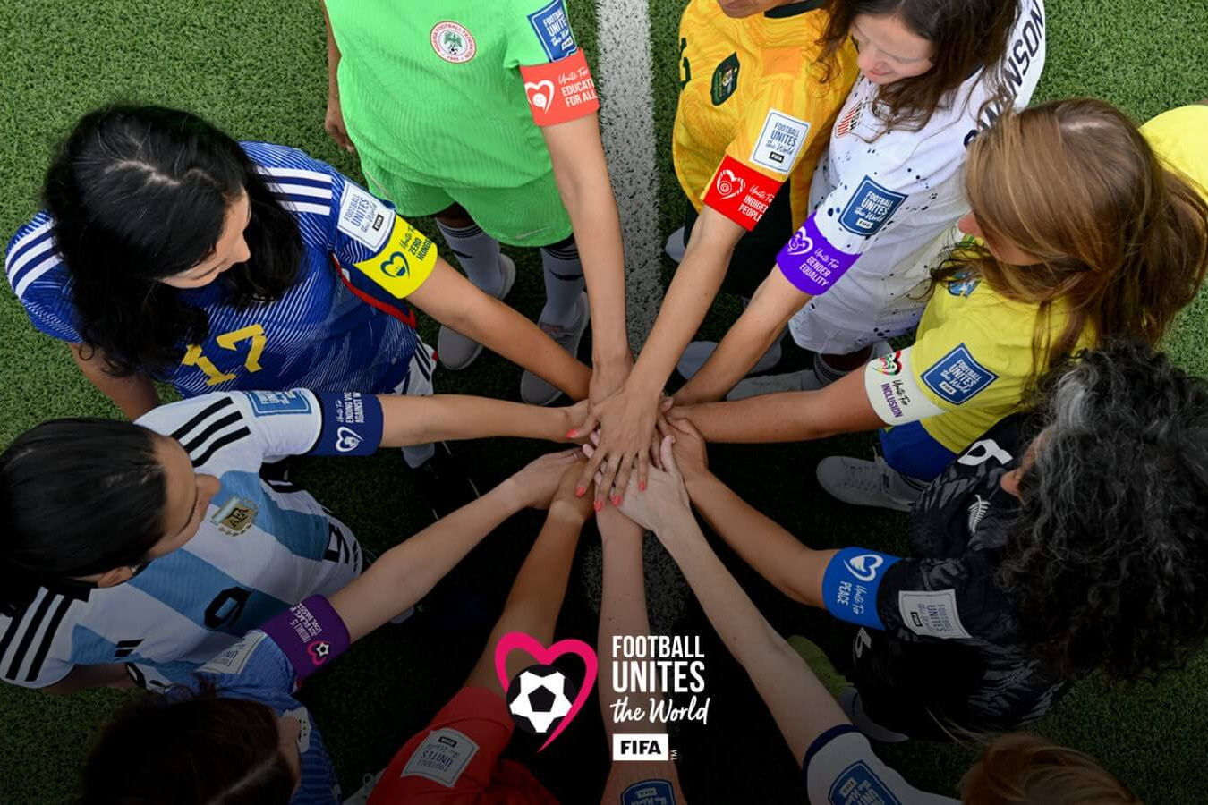 Female footballers doing a hand stack