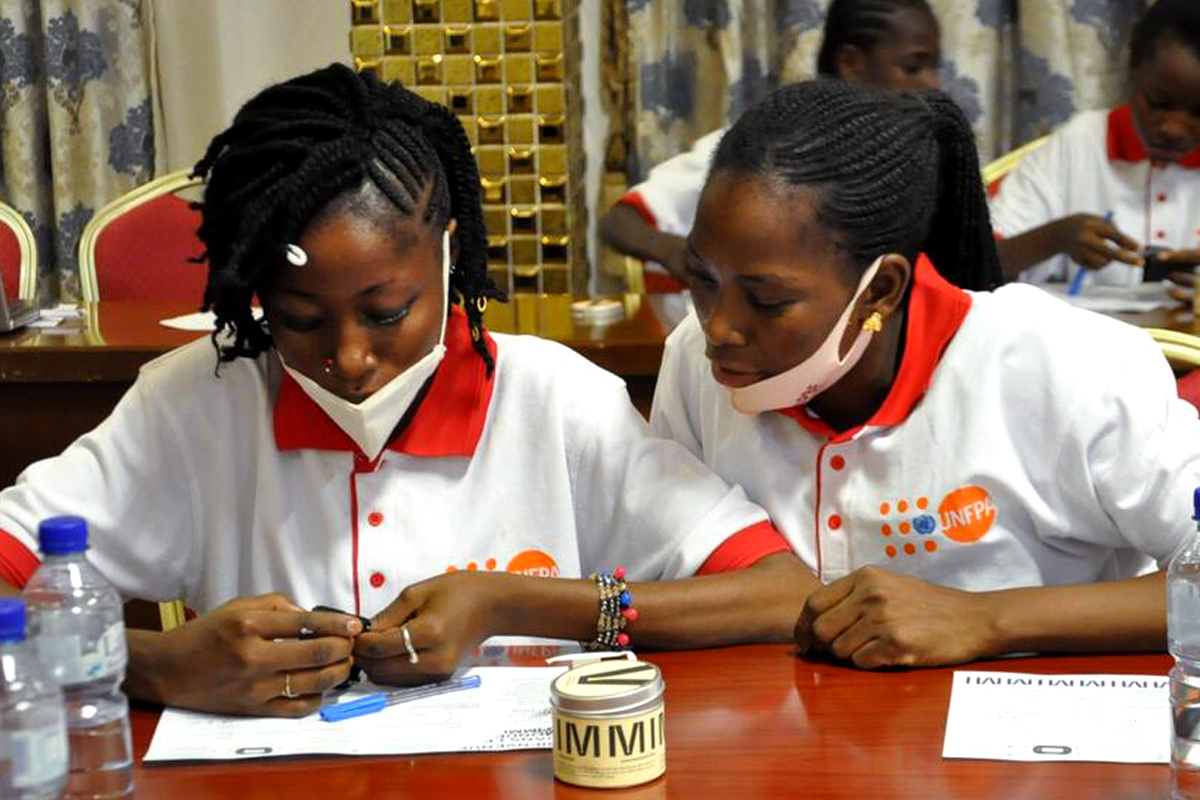Girls participating in the IMMI watch trial learn about their new devices at a workshop in Ouagadougou, Burkina Faso.