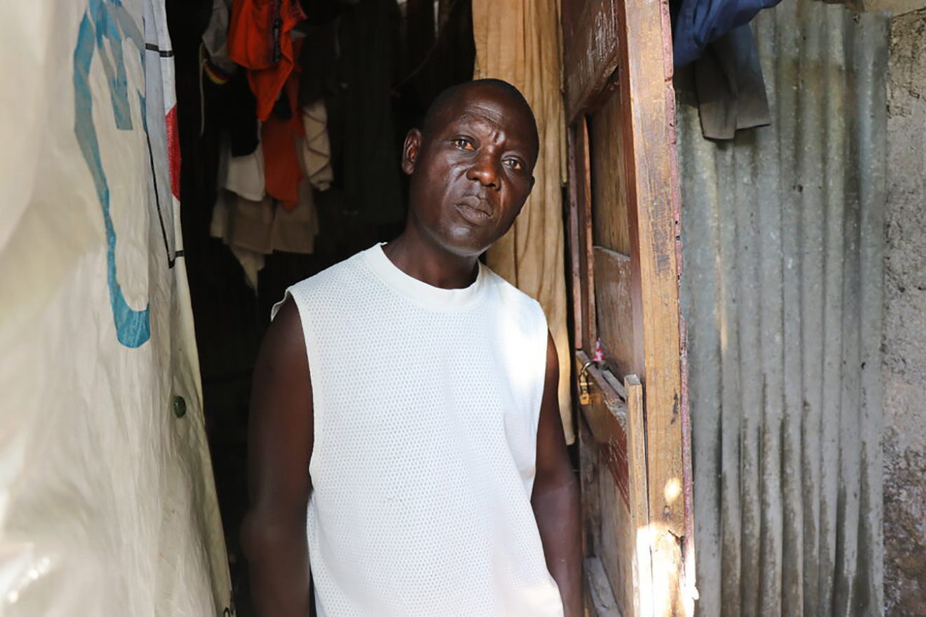 Portrait of Herman Petitfrere, a displaced Haitian who lives in a makeshift shelter built from wood and iron sheeting.