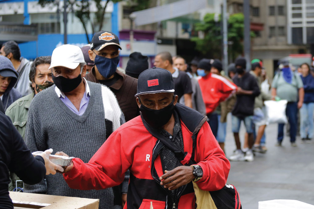 A line of people receiving donations. 