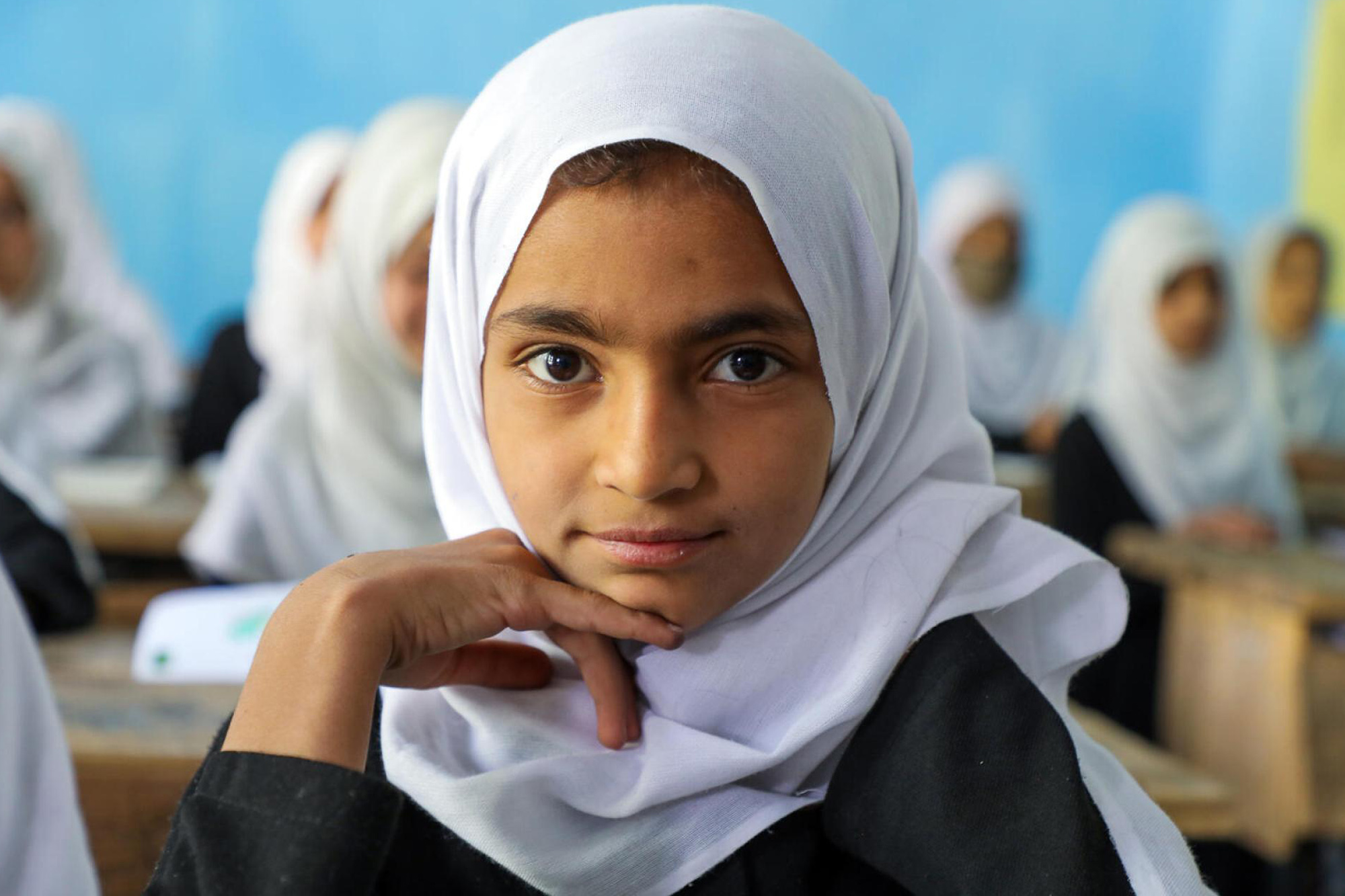 A girl sits in a classroom in Afghanistan.