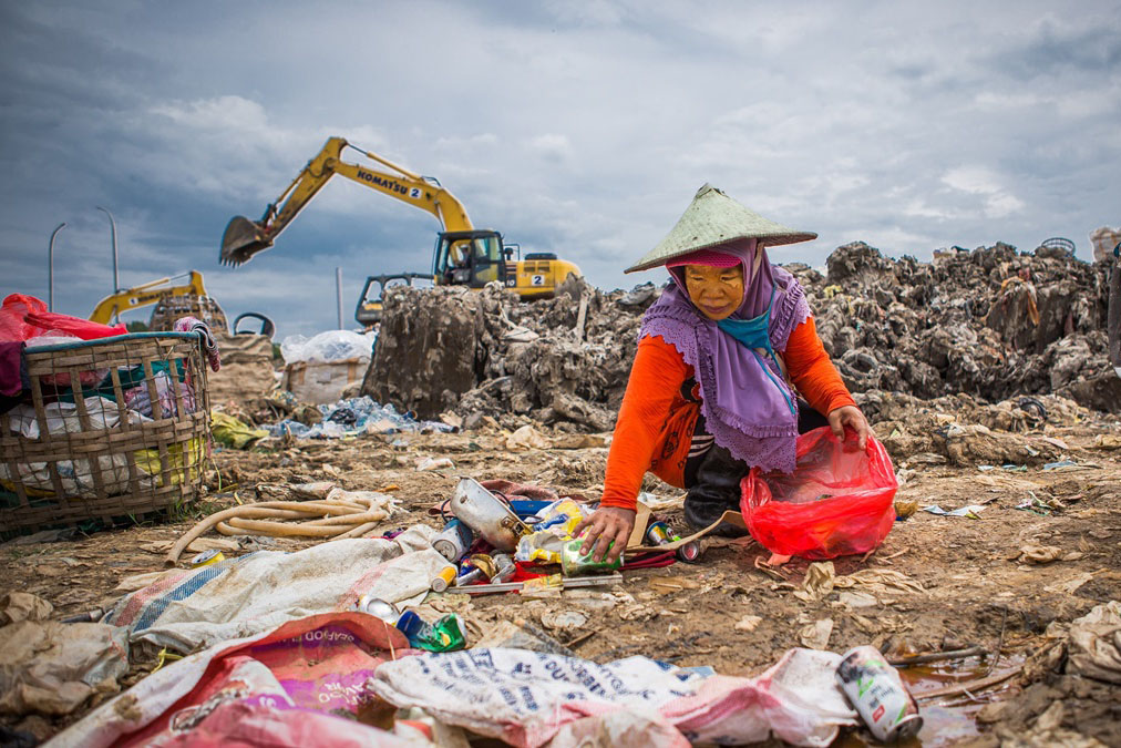 A woman sorts through waste in Balikpapan, Indonesia.