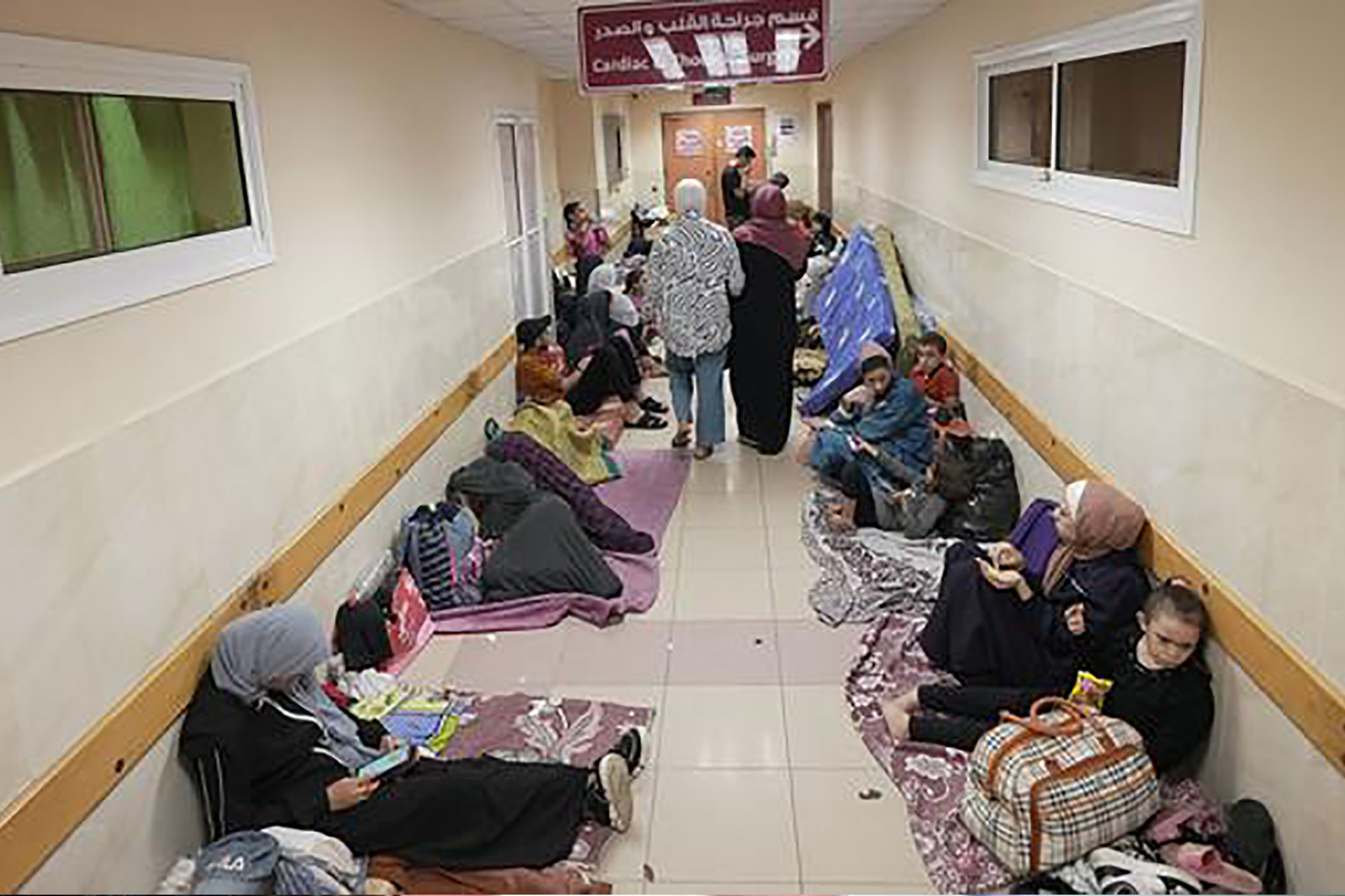 People stacked in a Gaza hospital hallway.