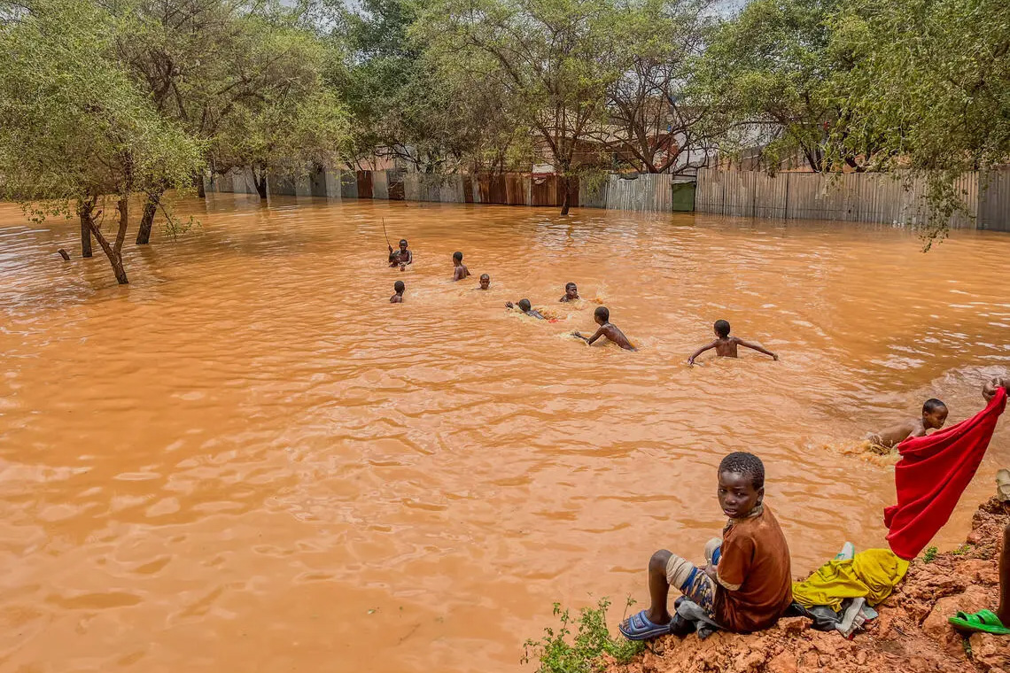 Children swim in flood waters