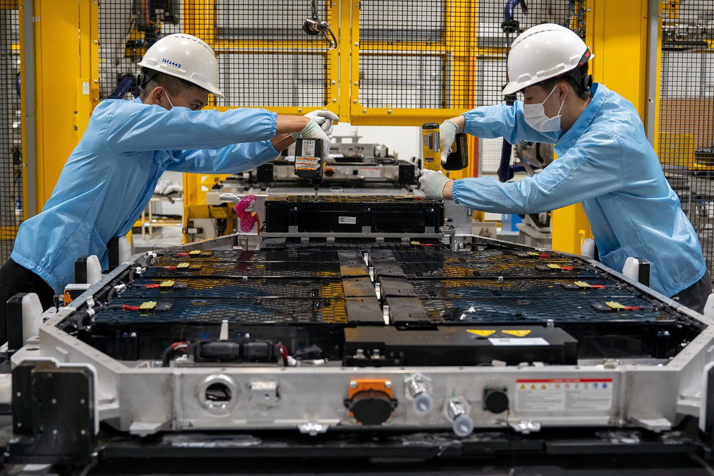 Workers at a car assembling factory.