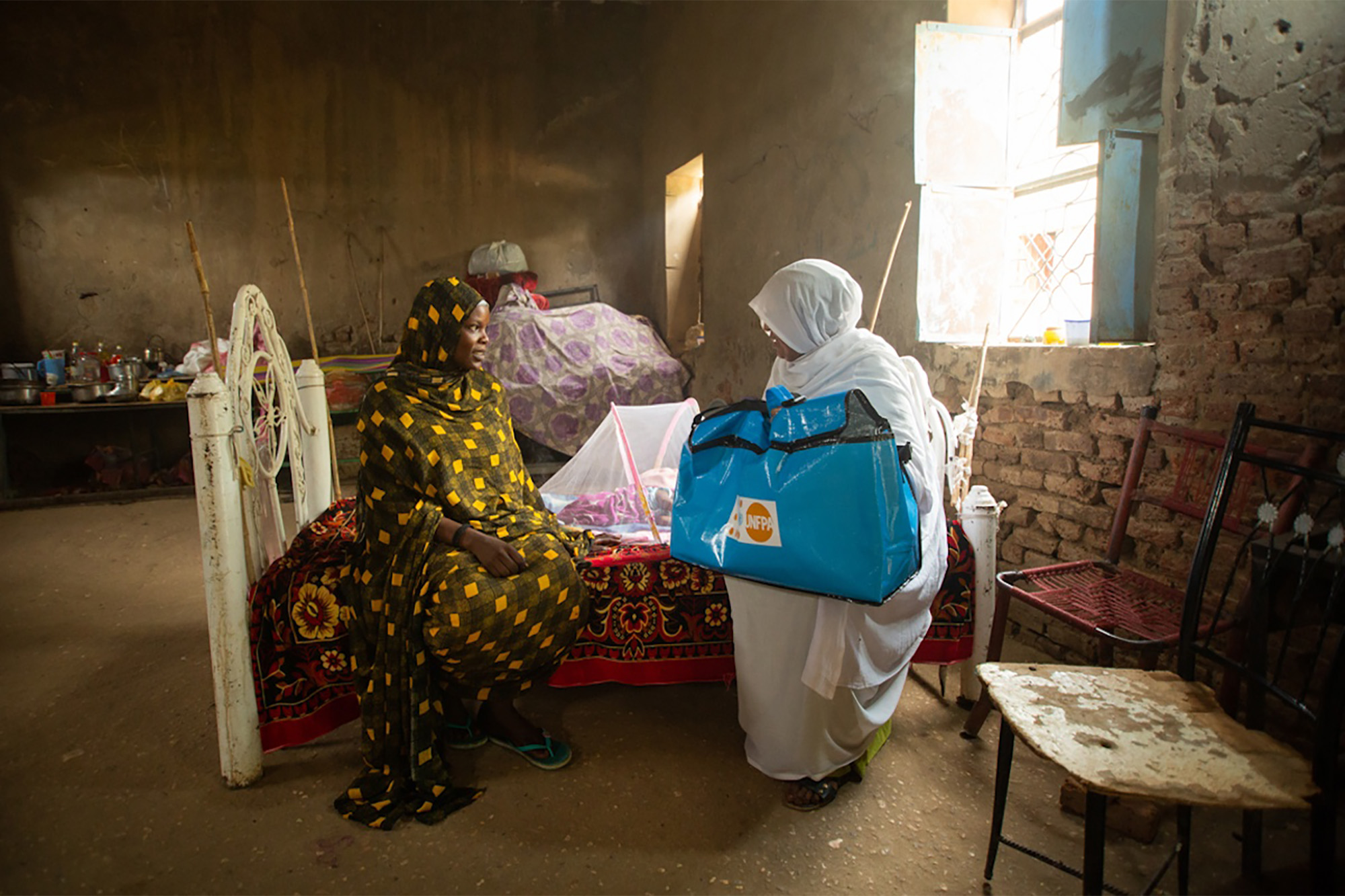 A health counselor visits a woman who has recently given birth.