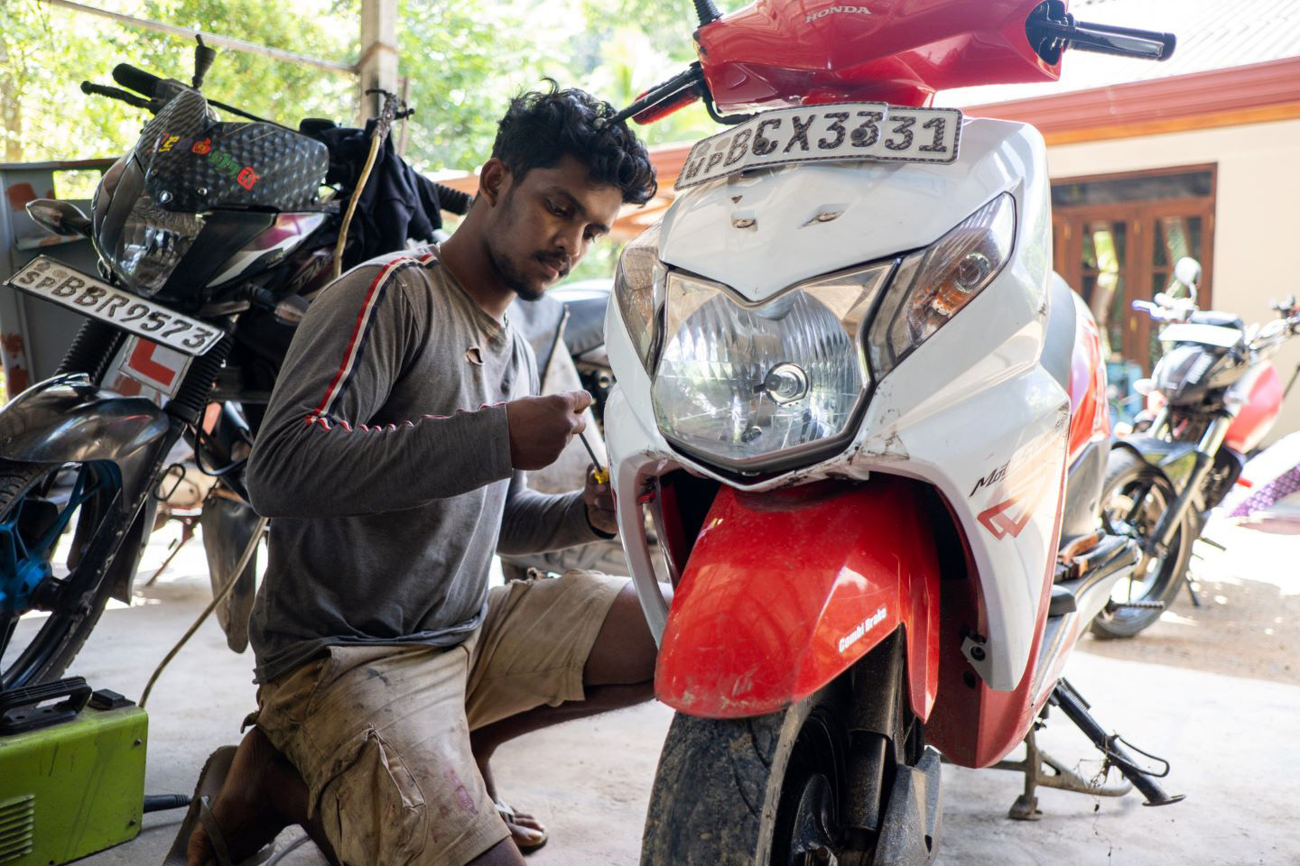 young man working on motorcycle