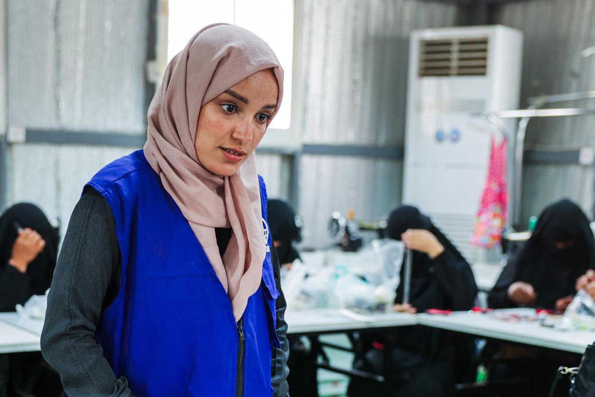 A Yemeni woman in an accessory-making workshop.