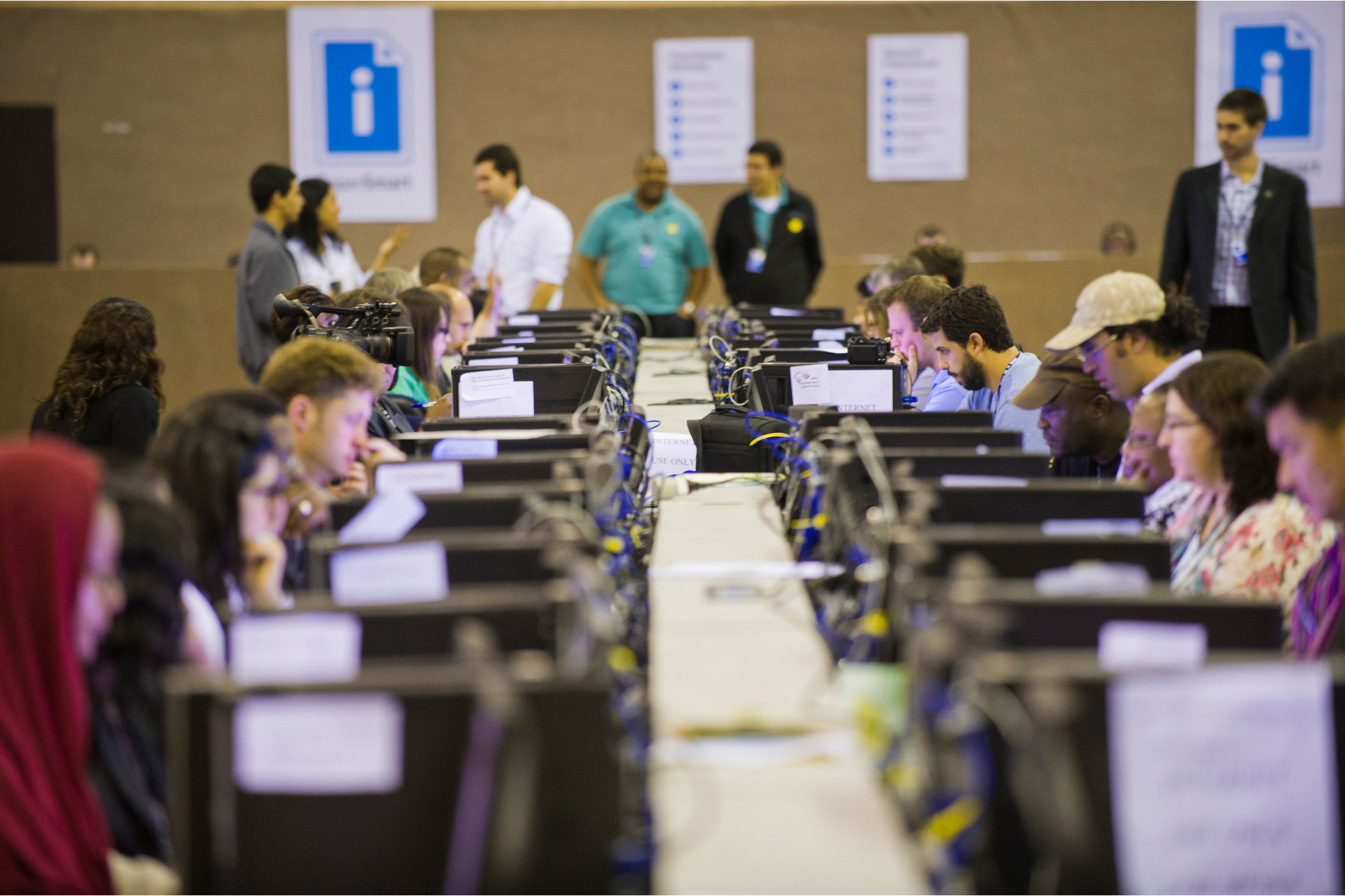 A group of journalists at work on their computers.