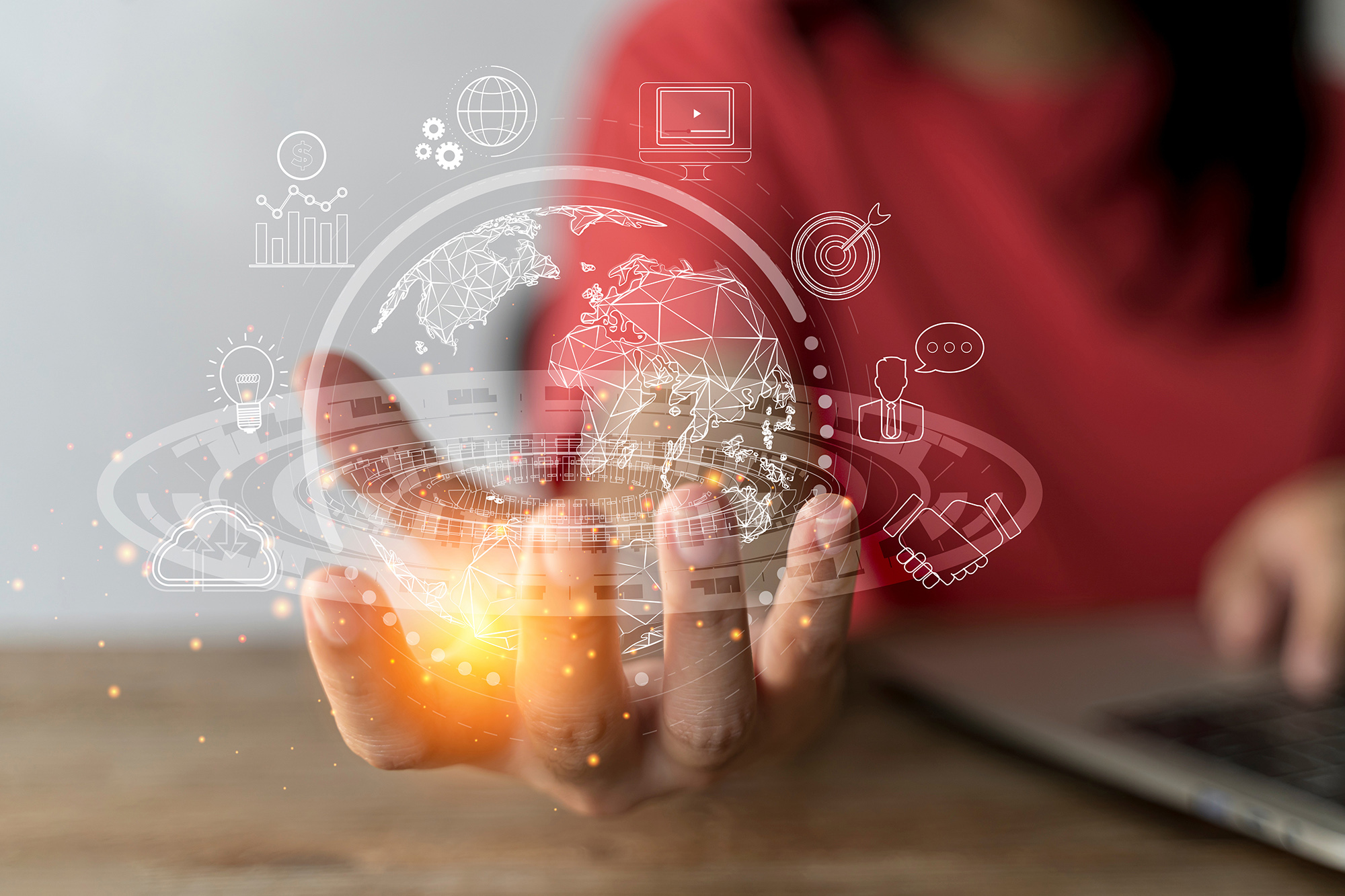  A young woman's hand holding a graphic representation of a virtual global internet connection metaverse.