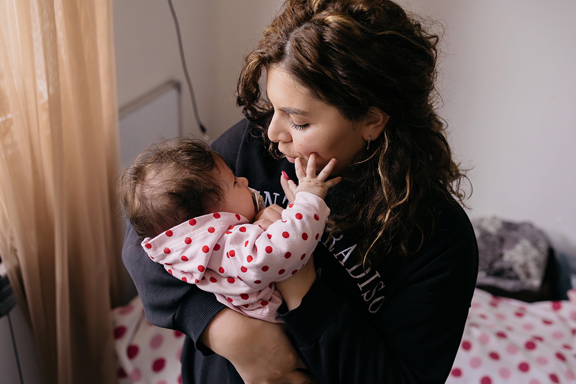 A mother holding a baby.