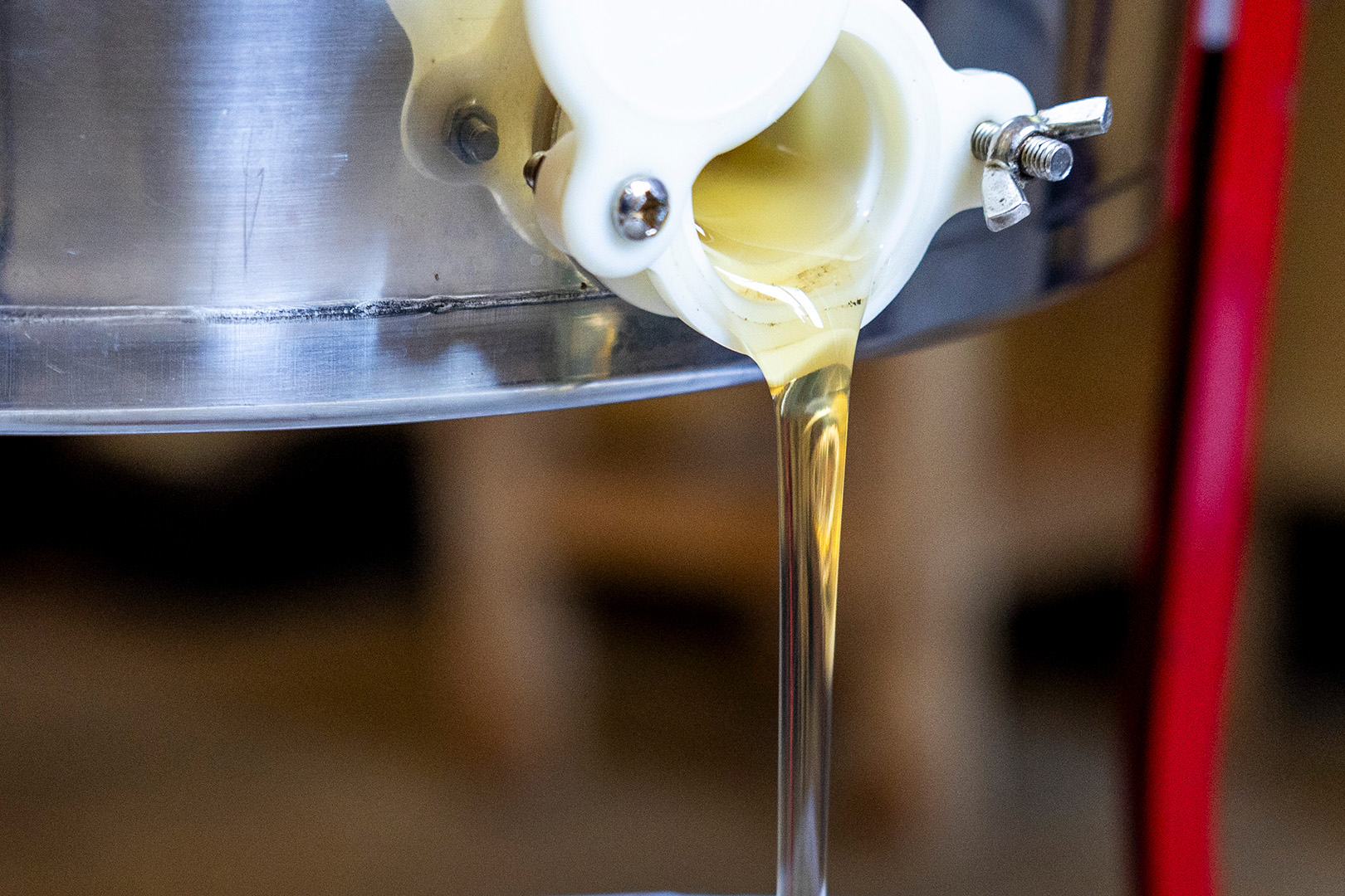 honey pouring out of vat