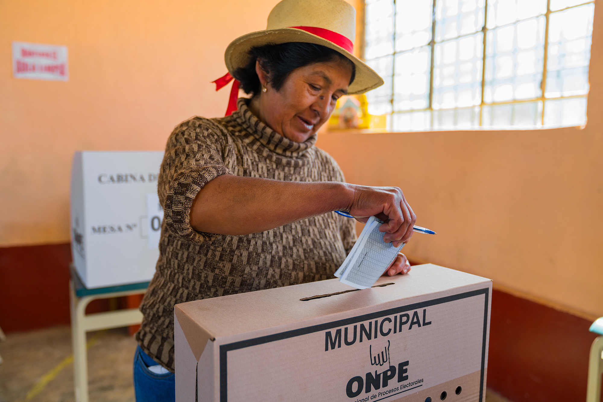 A woman casts her ballot in Peru.