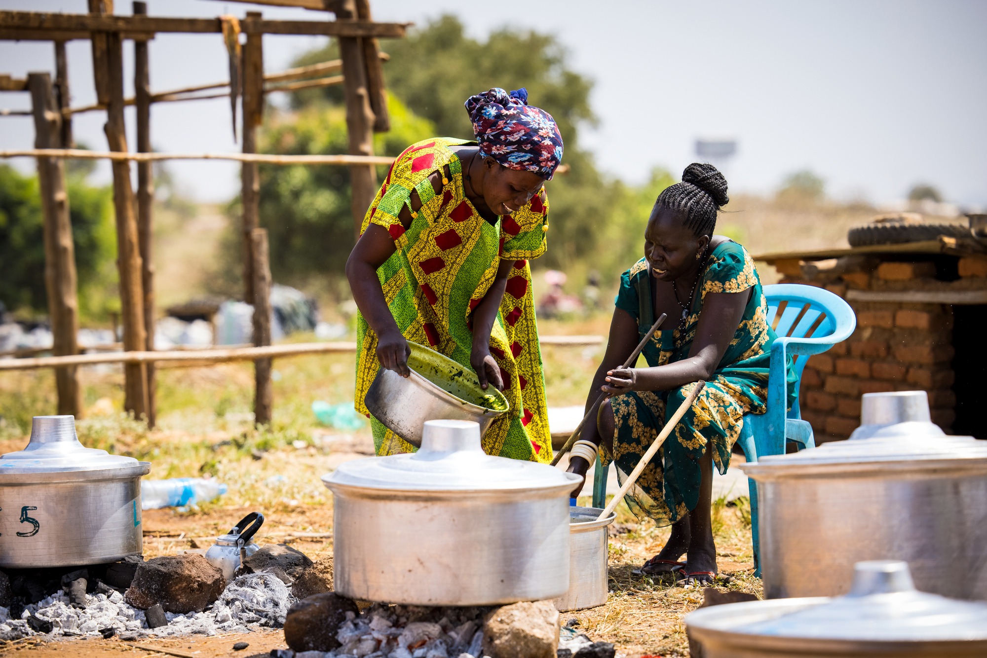 Two women prepare food for a community commemoration. Juba, South Sudan.