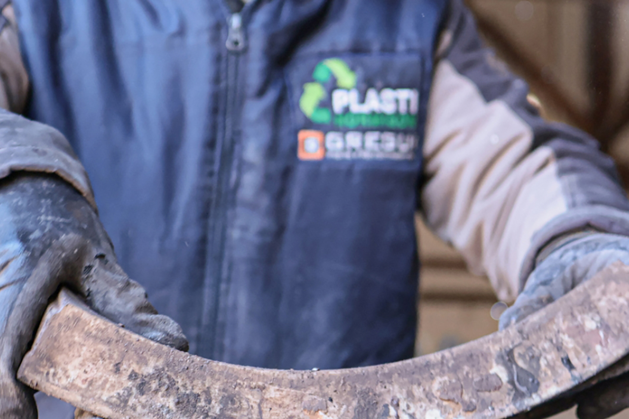 A worker handling a large piece of plastic