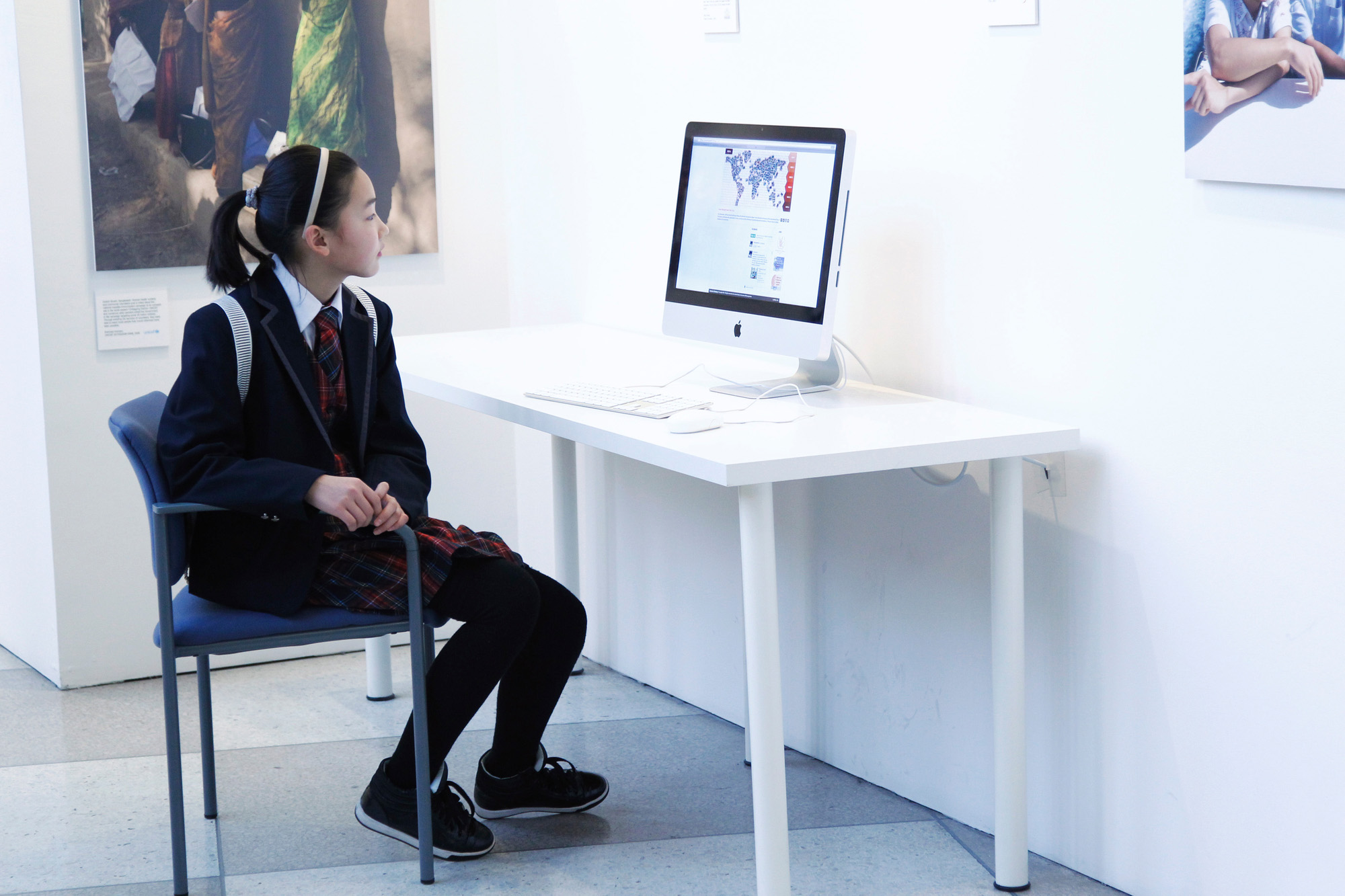 Girl looking at computer screen at UN headquarters.