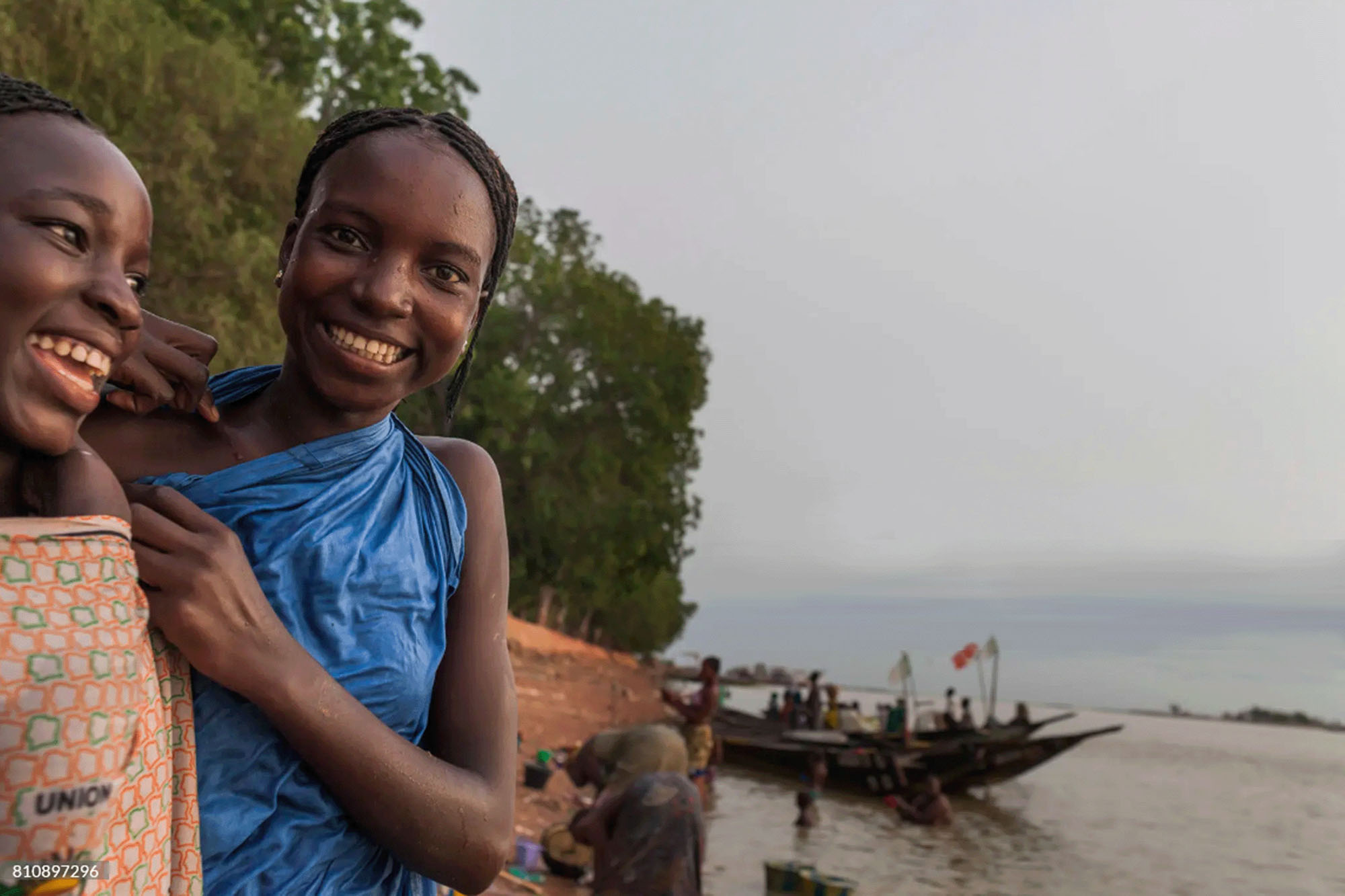 Two girls smile for the camera on the banks of the Niger River near the village of Diafarabe, Niger.