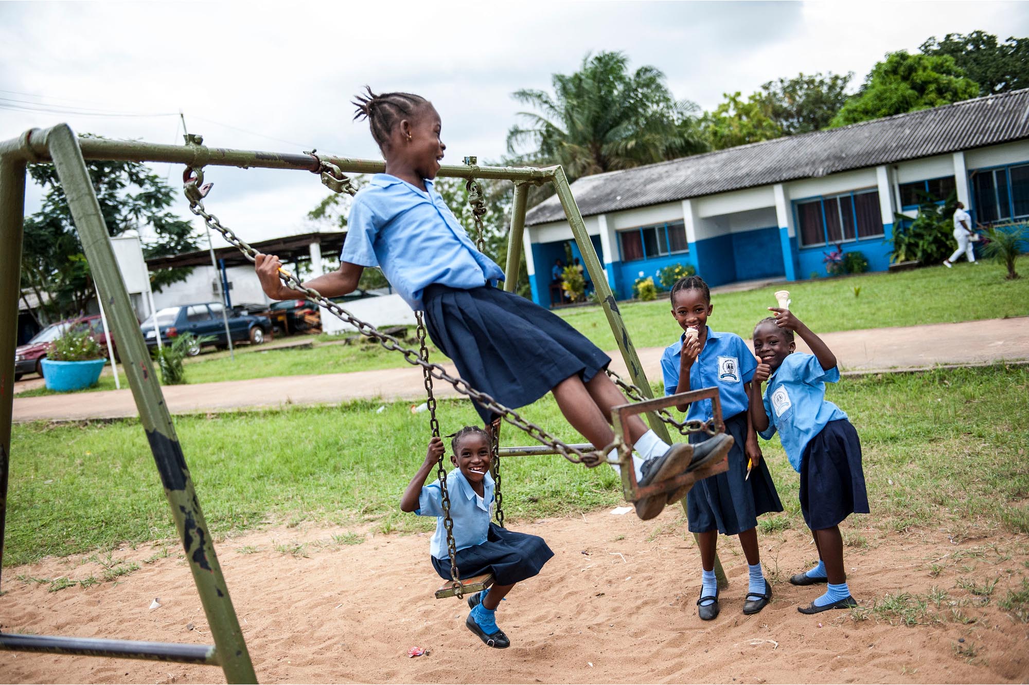 School children play on a swing during a UN Day outreach event organized by the United Nations Mission in Liberia (UNMIL) in Monrovia, Liberia.