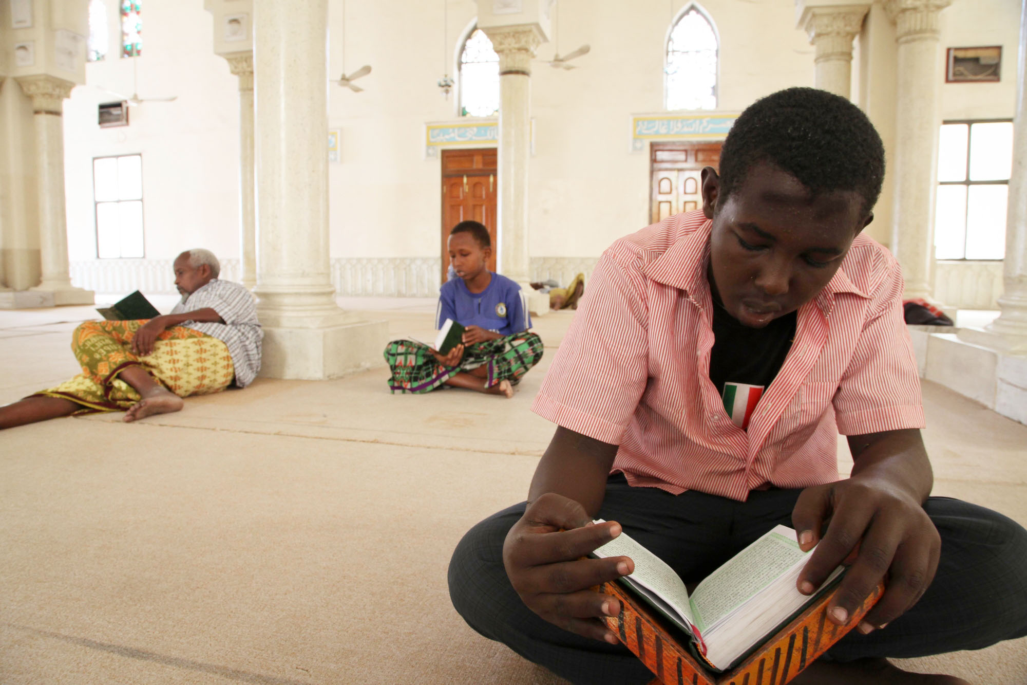 A boy reads from his Koran at a mosque in Mogadishu, Somalia, during the holy month of Ramadan.