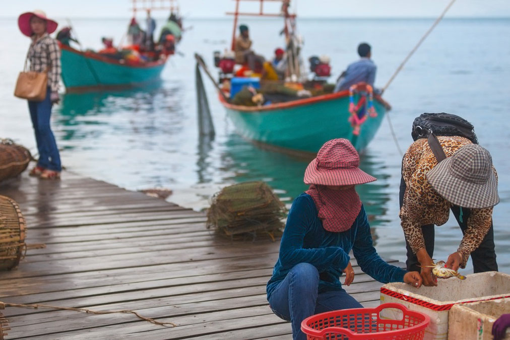 A couple of fish traders at a dock.