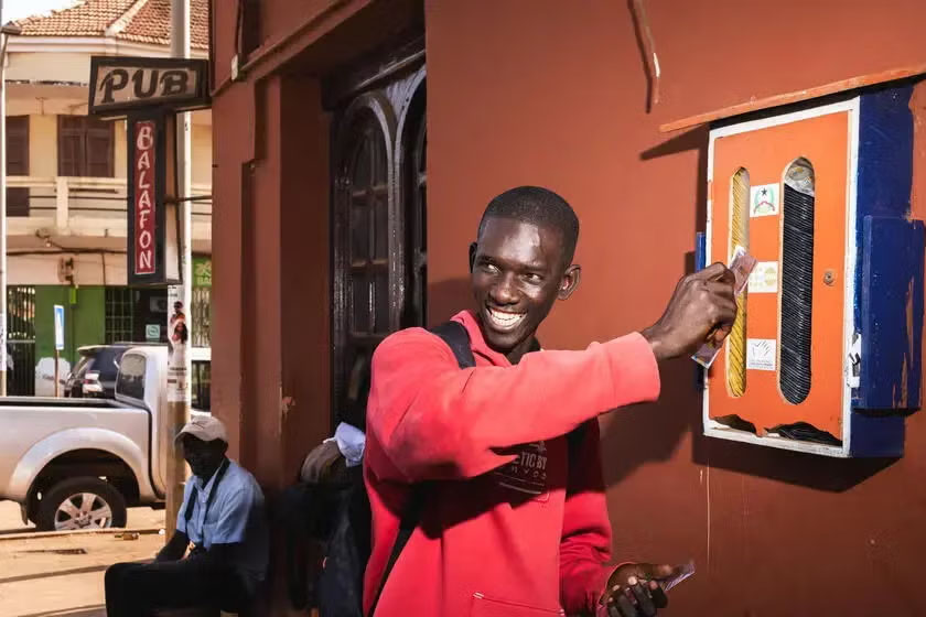 young man using condom dispenser