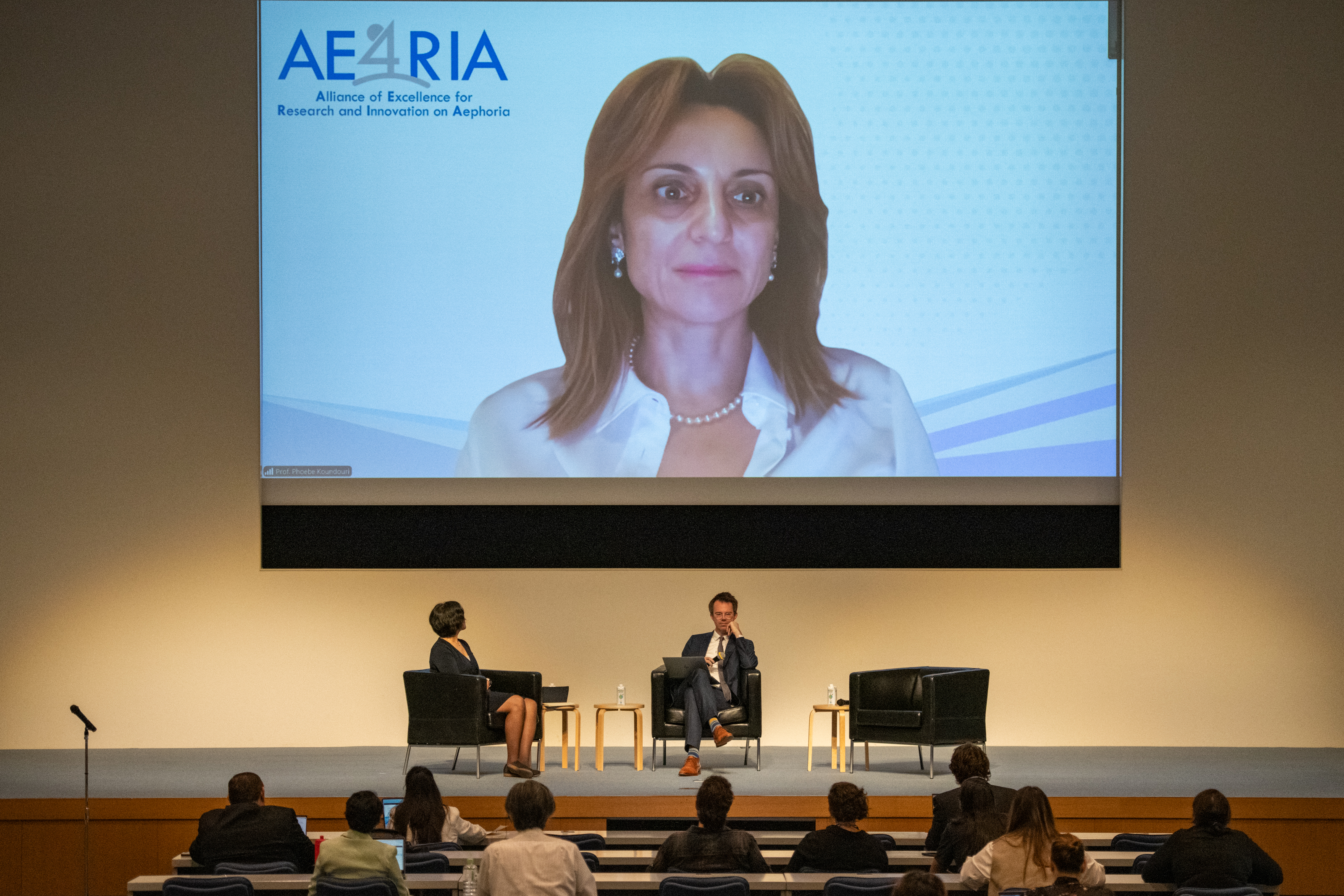 (Left to right) Yensi Flores-Bueso, Phoebe Koundouri (on screen), and Bregt Saenen during the ‘Policy’ panel. 
