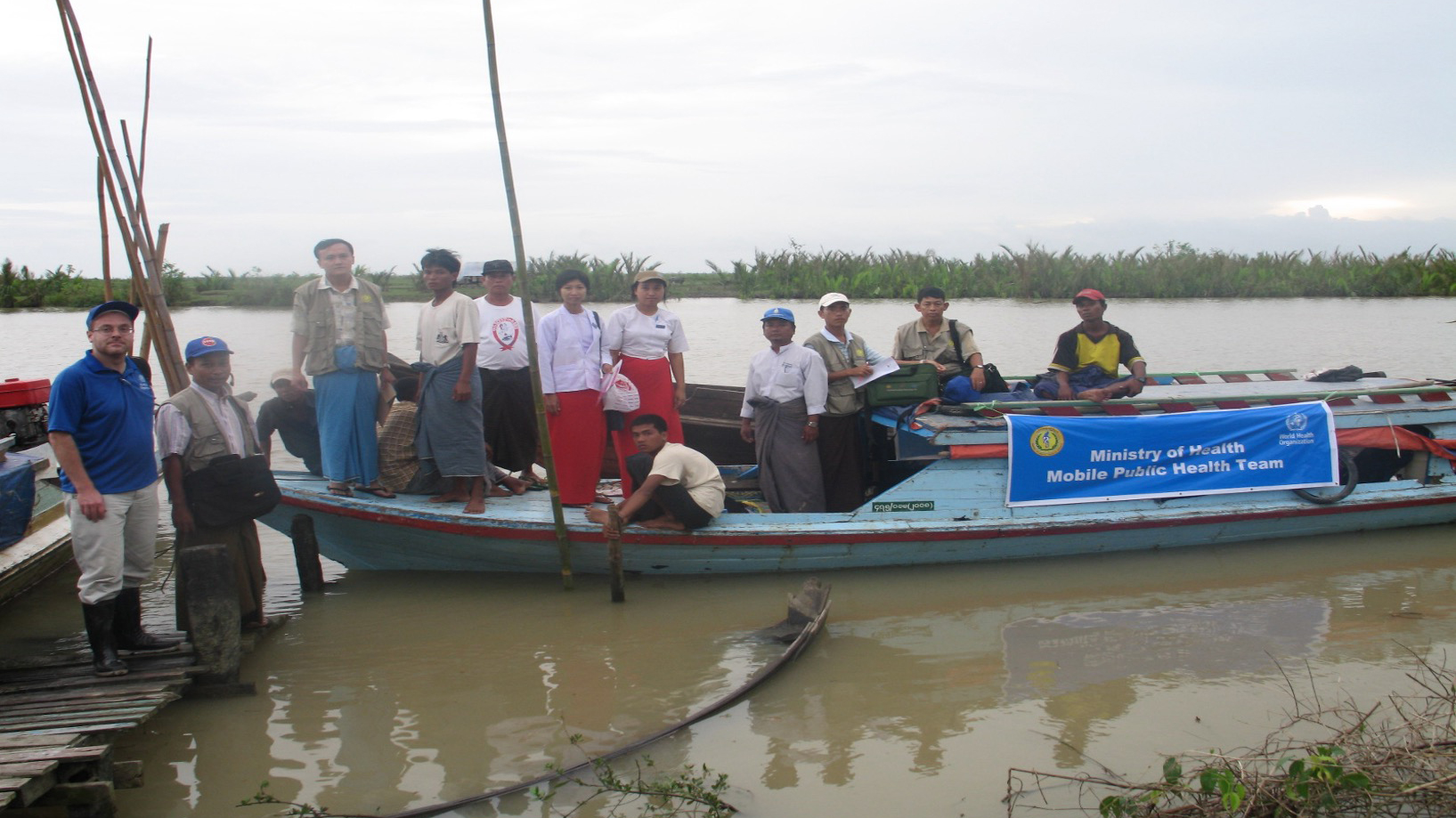 Hans standing in a boat witn many others