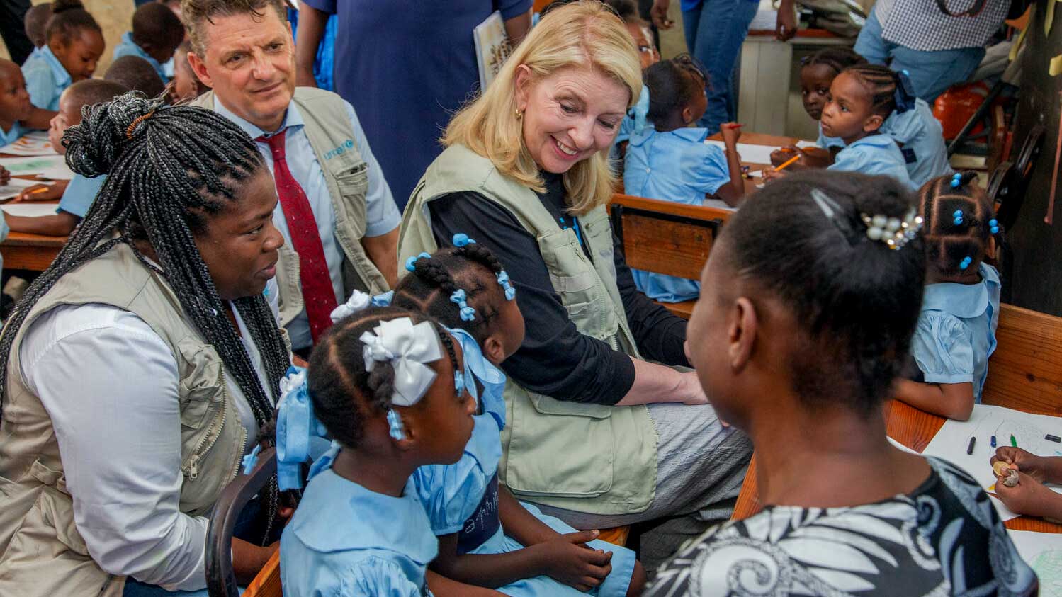 Catherine is seen in a classroom with children seated at their desks