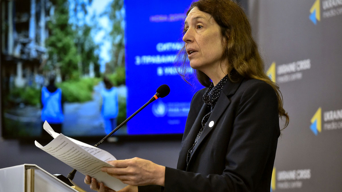 Matilda is at a podium delivering a statement