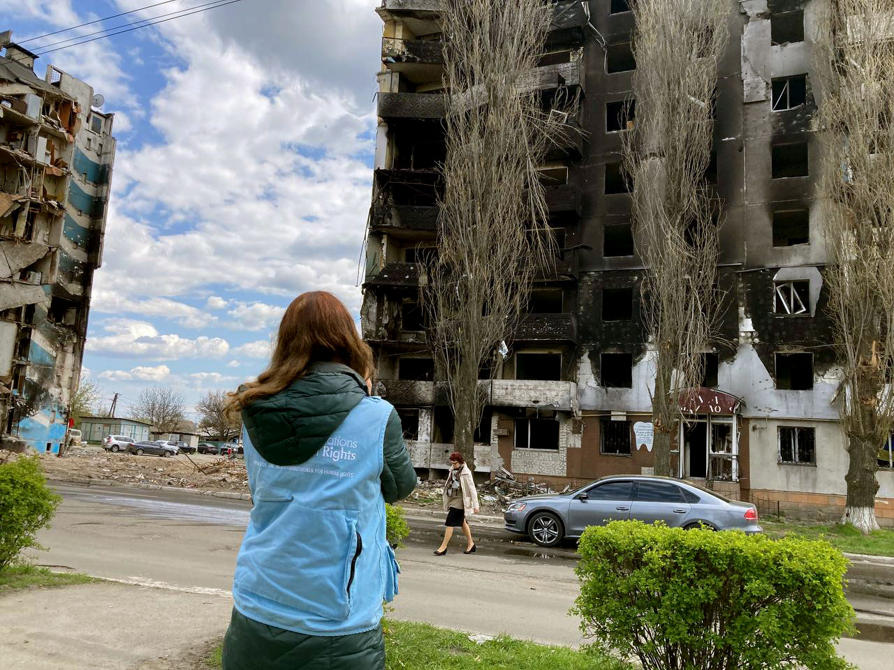 Matilda looks on a destroyed apartment block