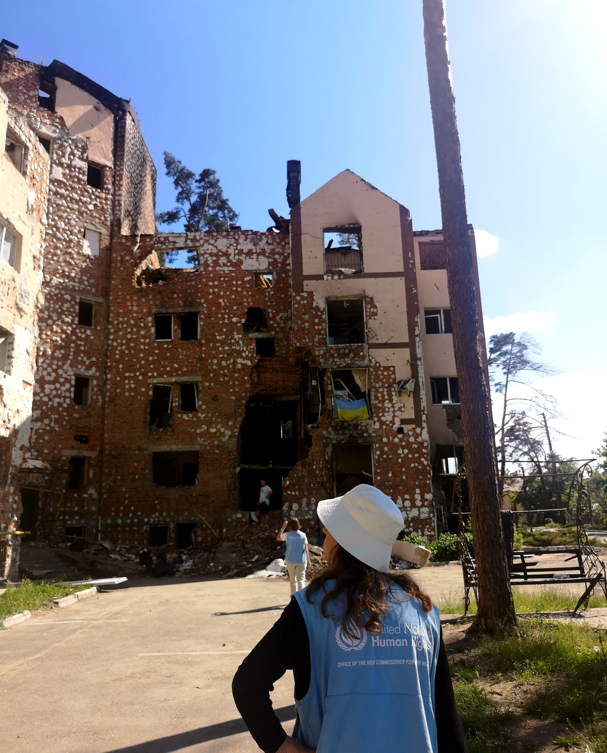 Matilda looks at a destroyed building