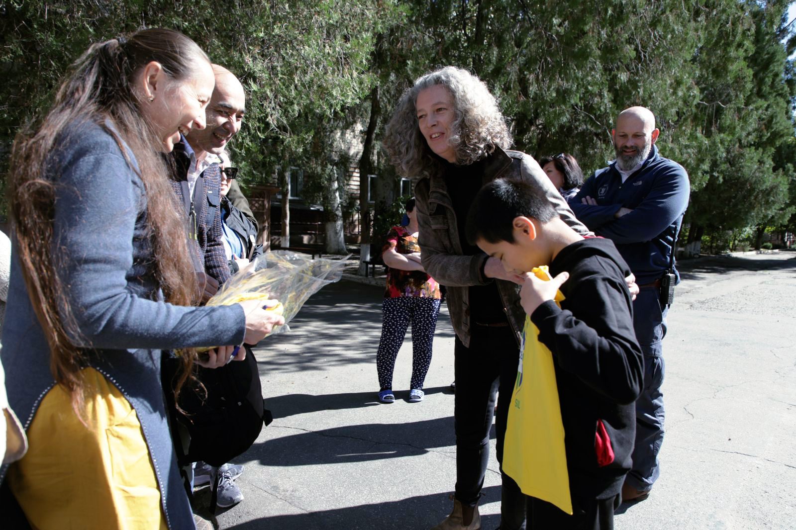 Denise is chatting with others in the outdoors