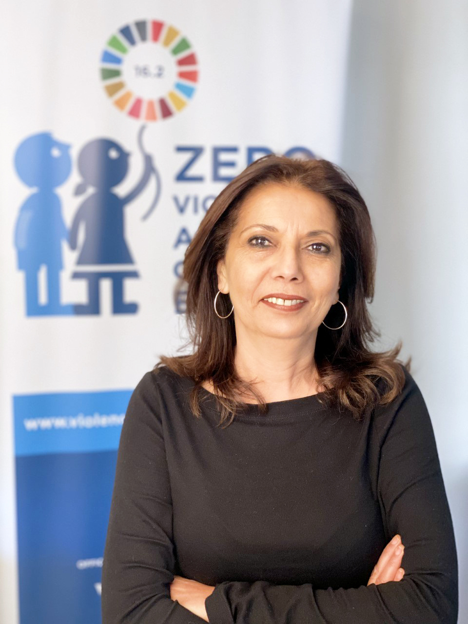 portrait photo of Najat with the sustaible goals logo behind her