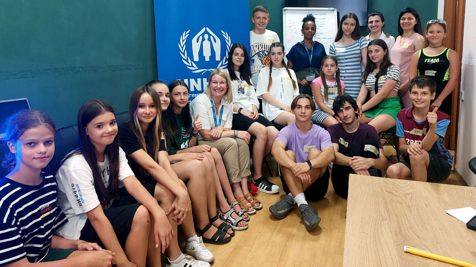 Karolina in a group photo with children at a youth center