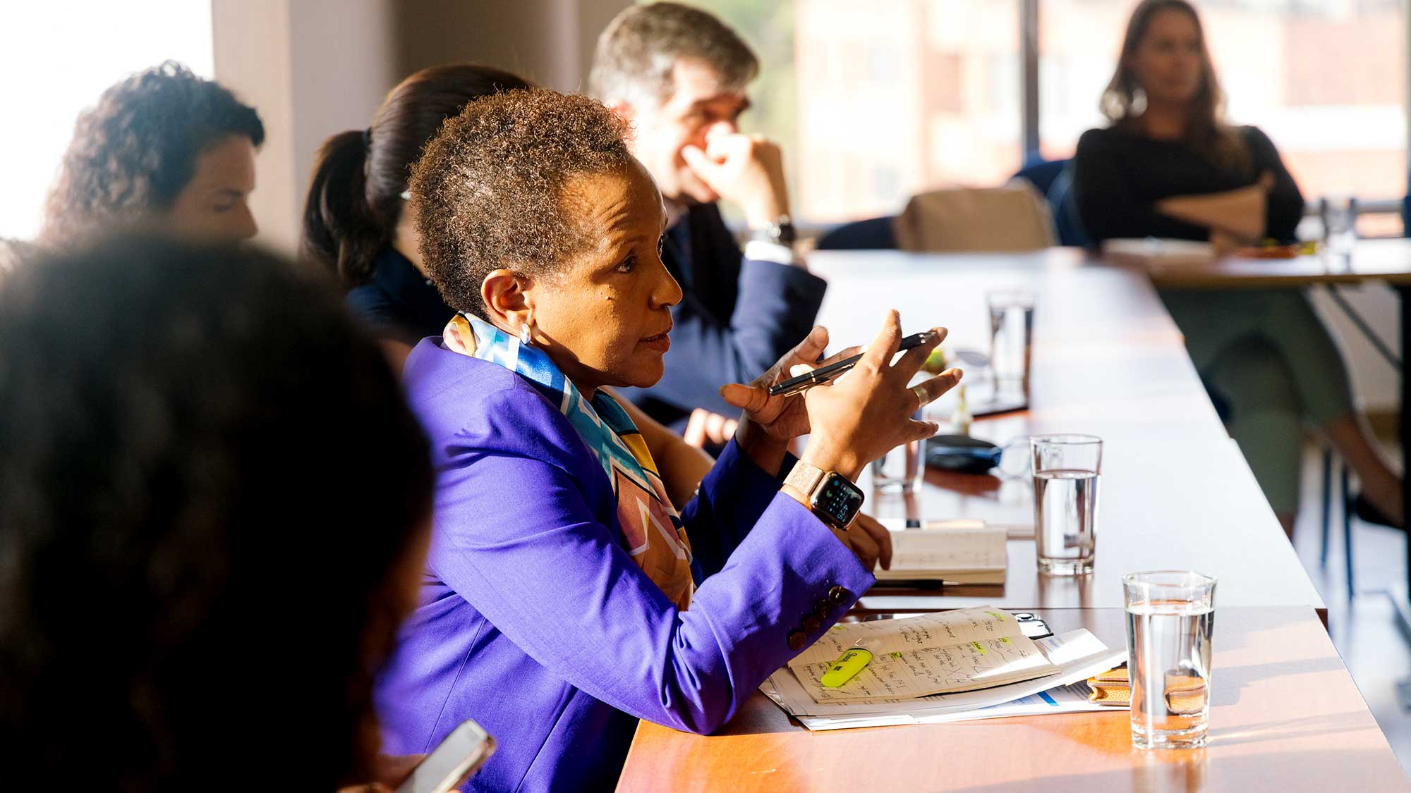 Msuya is in deep discussions at a table with others