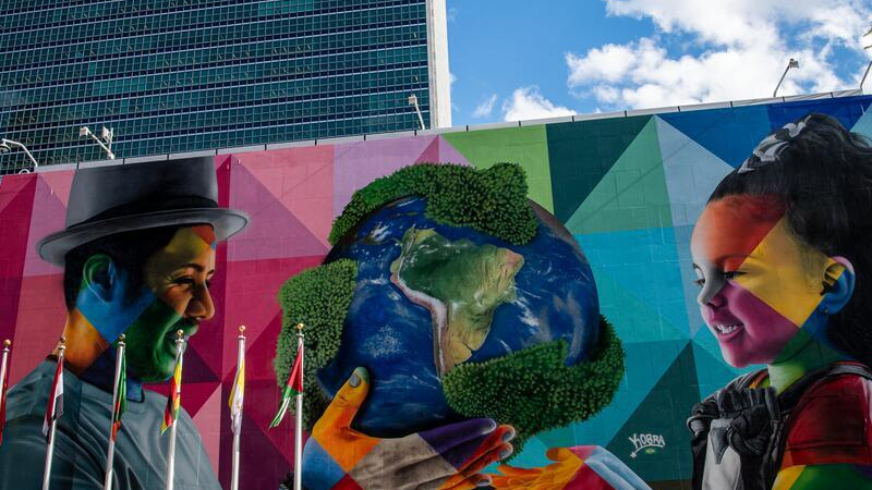 A view of the Eduardo Kobra mural at UN Headquarters: An adult is giving our planet to a child