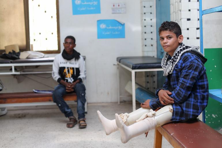 wounded child with prosthetic legs