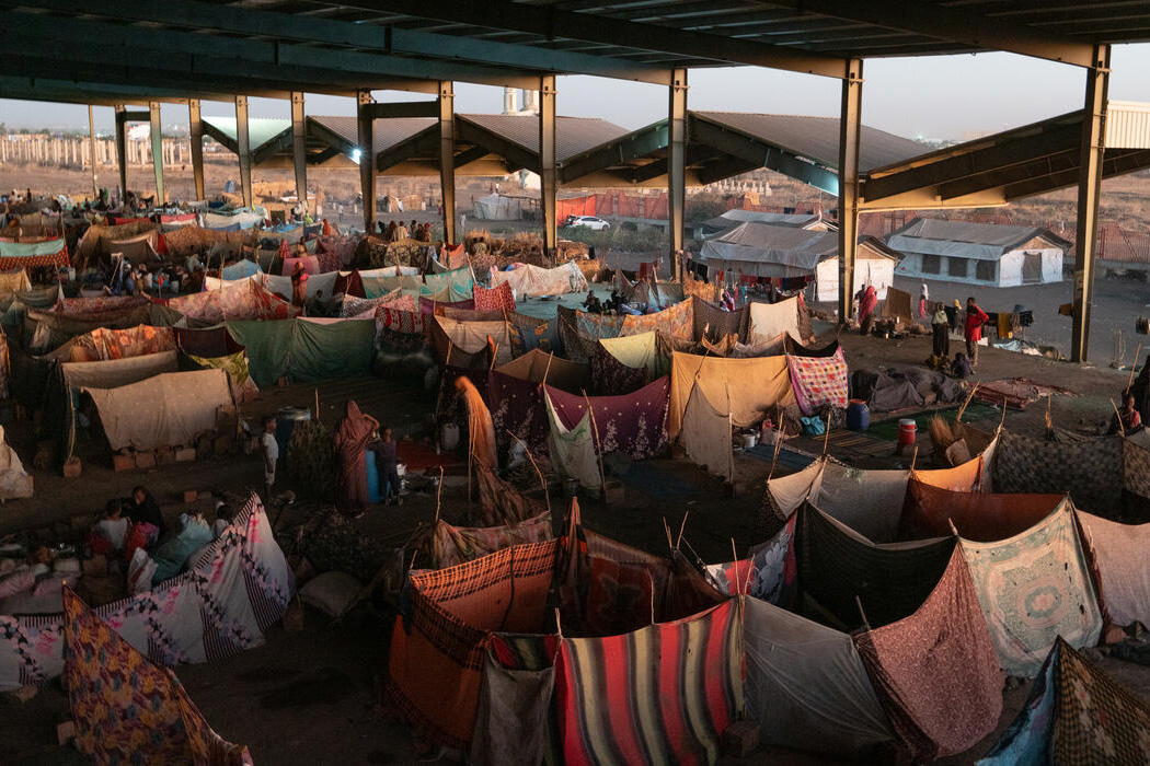 Camp for displaced people, with hanging fabric pieces giving a semblance of intimacy.