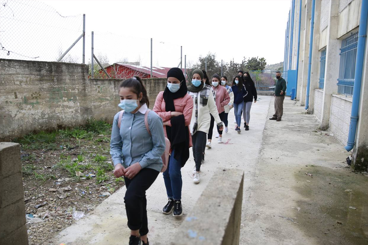 students leaving school through emergency exit