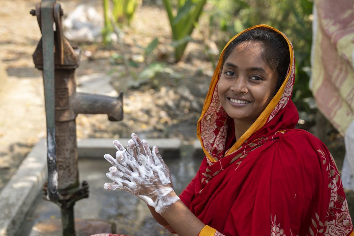 Eti washes her hands and smiles