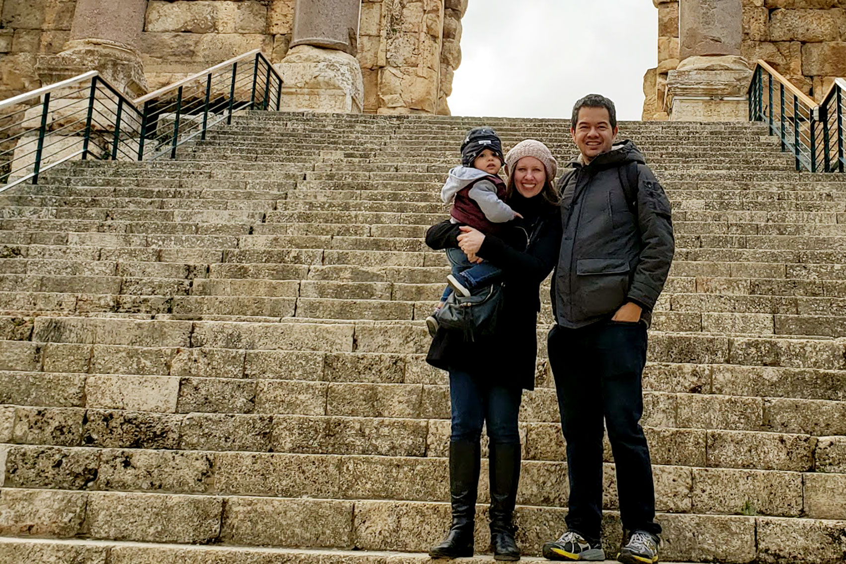 Family portrait at the steps of a historic site.
