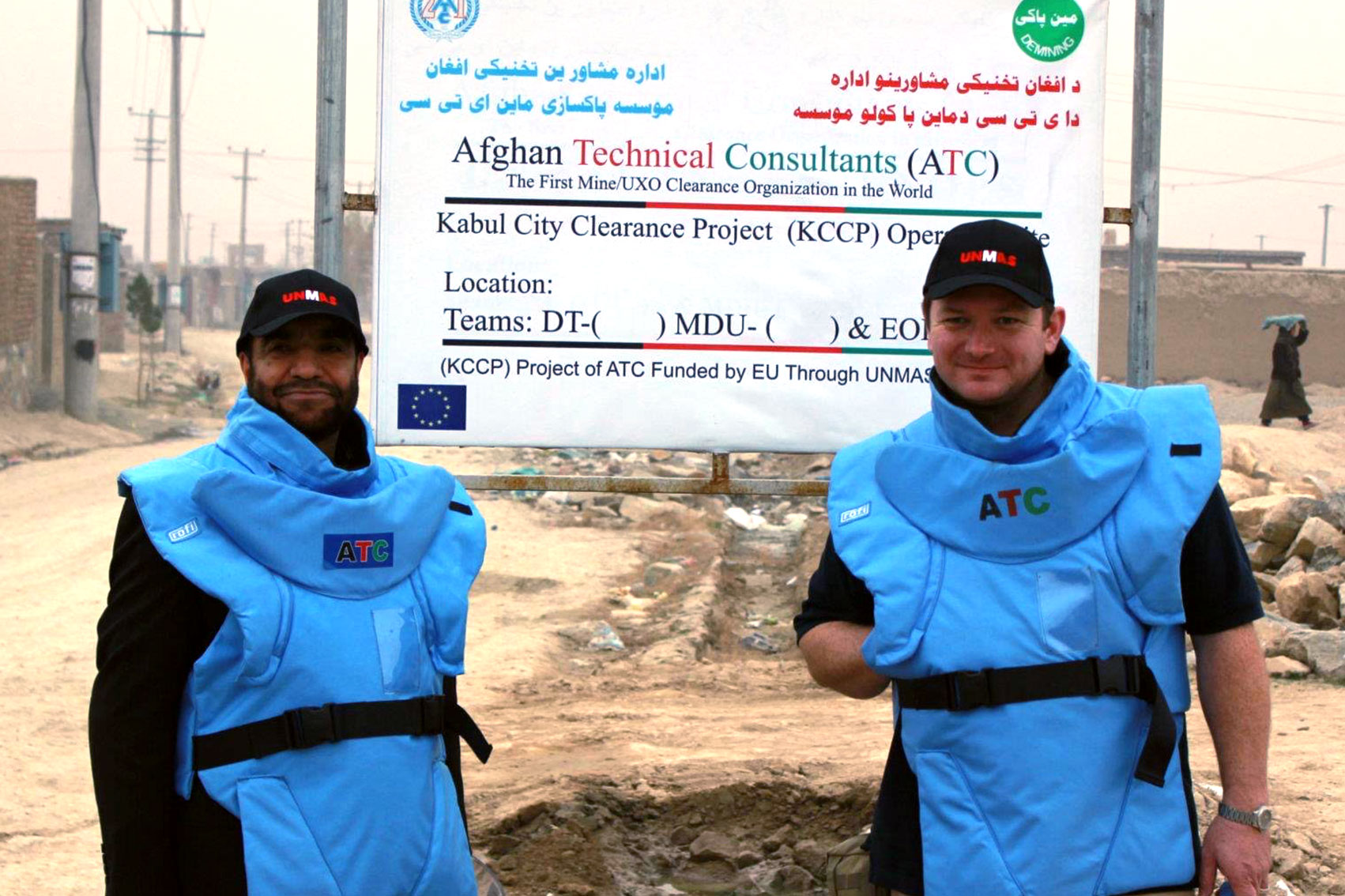 Paul Heslop and Kef Alatulla pose for a photo wearing protective body vests.