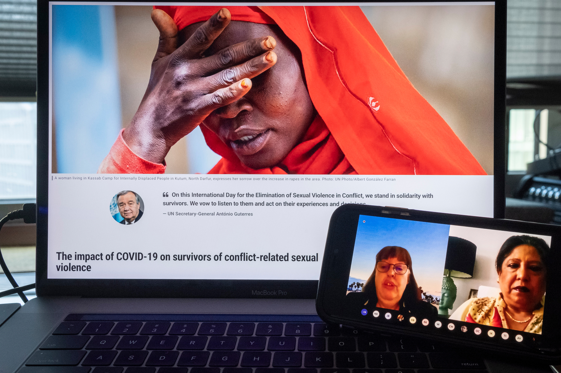 Photo of a computer screen that is on the webpage "the International Day for the Elimination of Sexual Violence in Conflict" and a smartphone with Virginia Gamba and Pramila Patten.