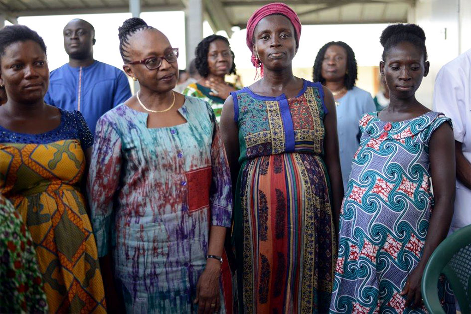 Dr. Moeti stands next to pregnant women.