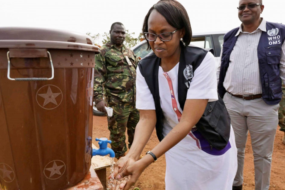 Dr.Moeti washes her hands at a portable wash station.