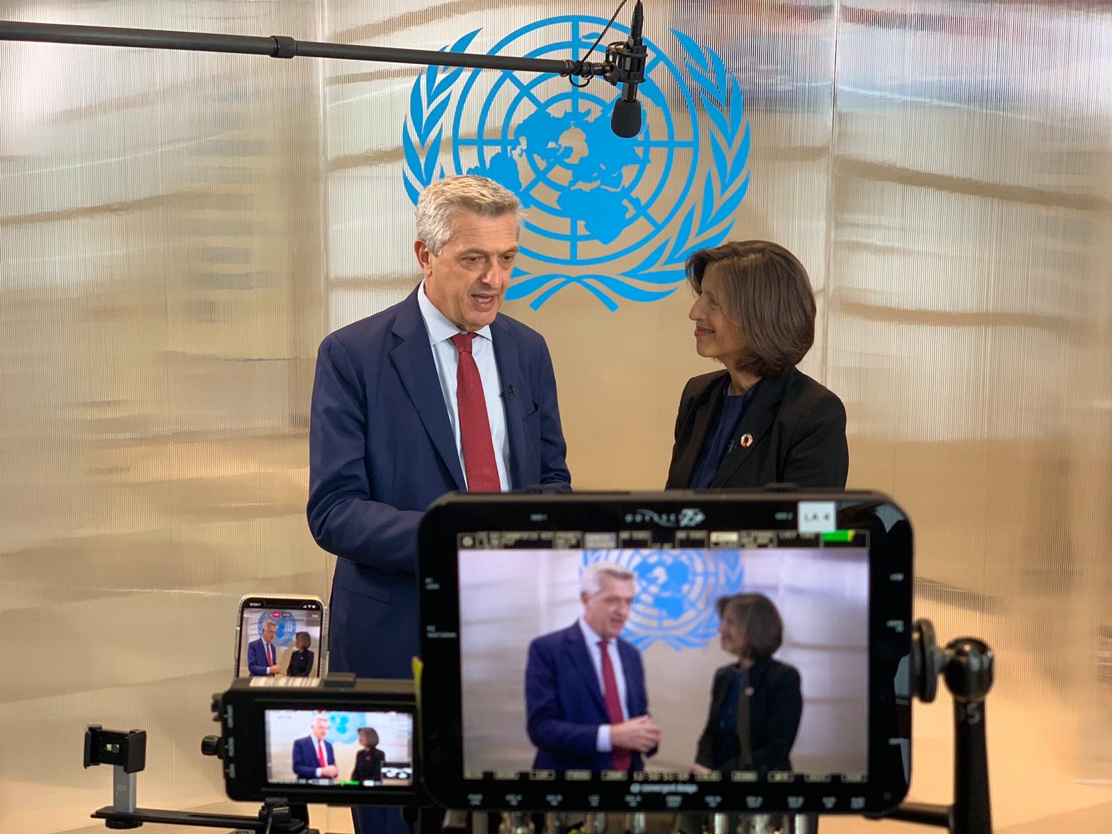 Cameras record a UN official interviewing another.