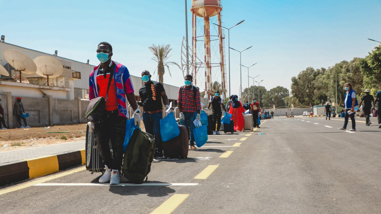 A line of Ghanaian migrants in Tripoli, Libya waiting to fly back home.