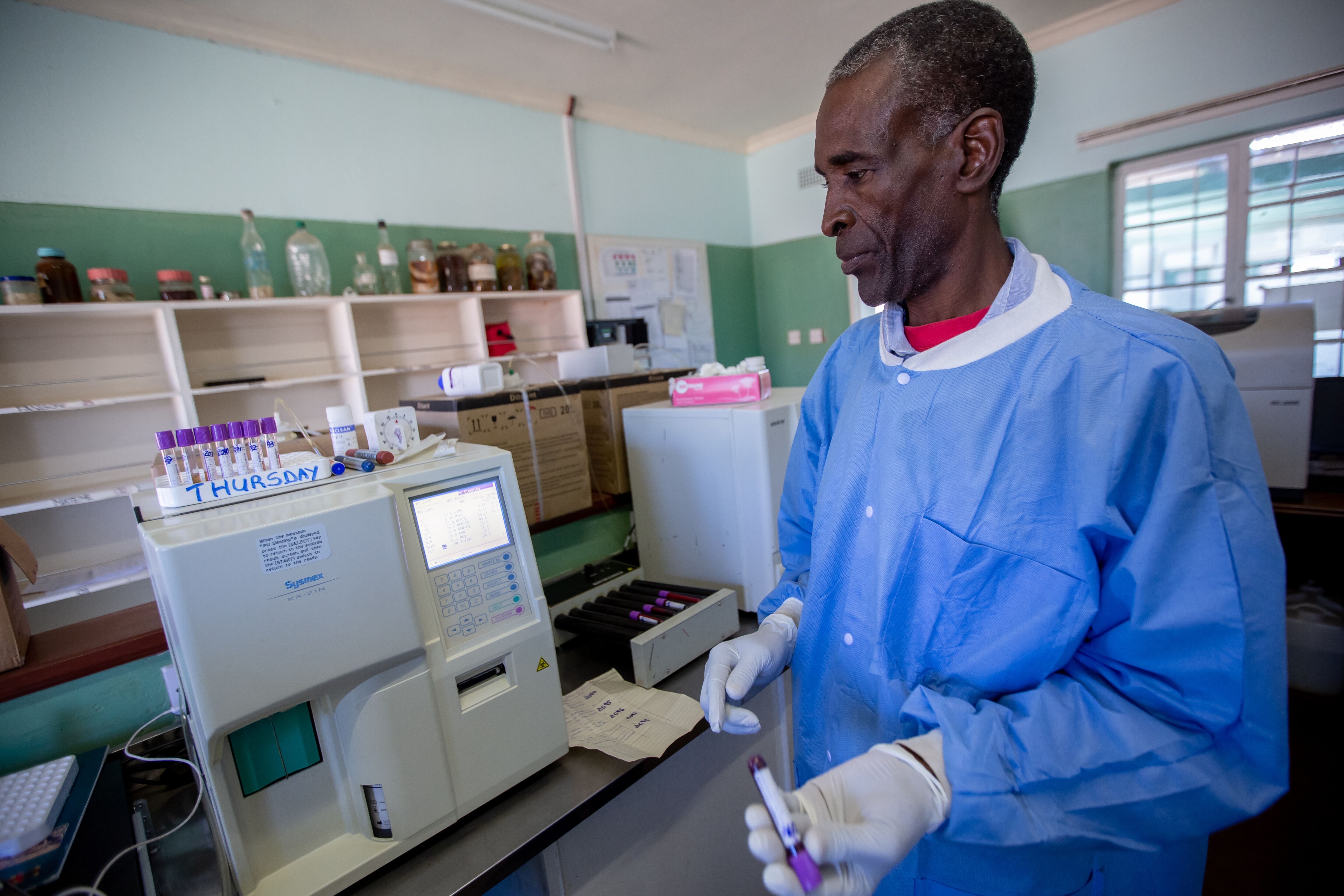 Following the installation of solar panels, medical laboratory scientists at the Nkayi District Hospital are able to work without the interruption of power cuts. UNDP/Slingshot