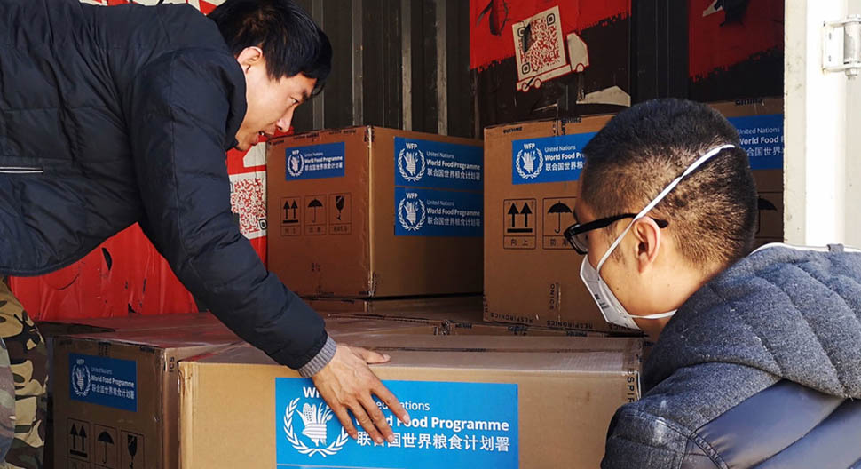 men with masks unloading truck