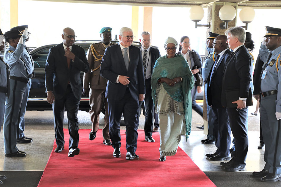 Bangura walks on a red carpet with the German President.